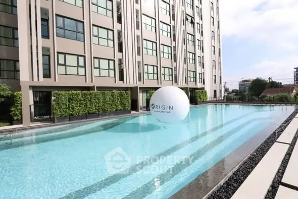 Luxurious condominium with a stunning outdoor pool and modern architecture.