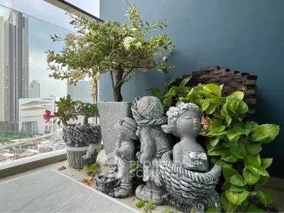 Charming balcony with city view and decorative garden statues.