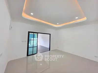 Spacious modern living room with recessed lighting and large sliding doors.