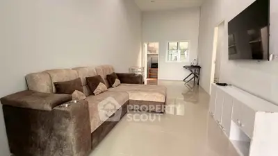Spacious modern living room with plush sectional sofa and wall-mounted TV