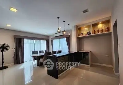Spacious modern living room with elegant dining area and stylish lighting.