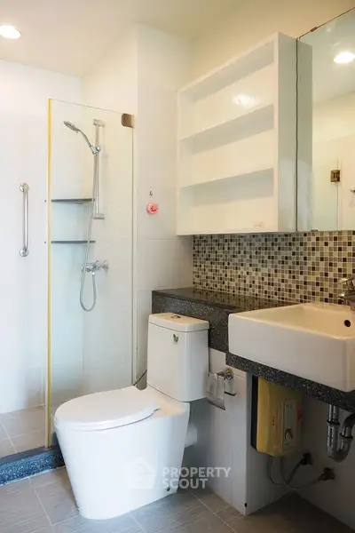 Modern bathroom with sleek fixtures and mosaic tile accents