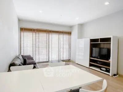 Modern living room with sleek furniture and large windows for natural light.