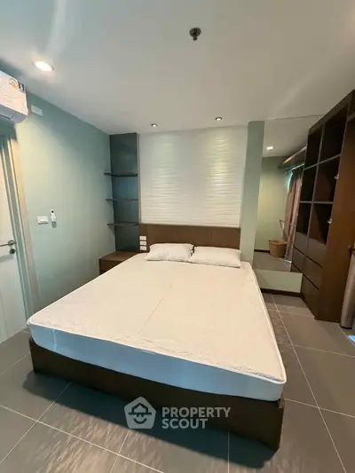 Modern bedroom with sleek design and ample storage in a stylish apartment.