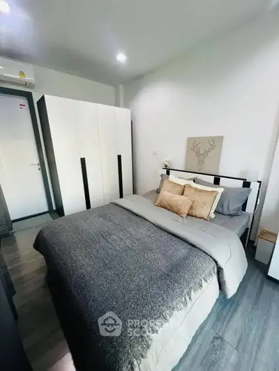 Modern bedroom with stylish decor and ample storage space