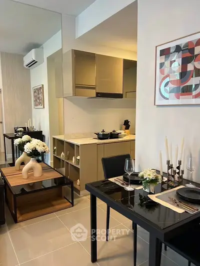 Modern dining area with sleek kitchen and stylish decor in a contemporary apartment.