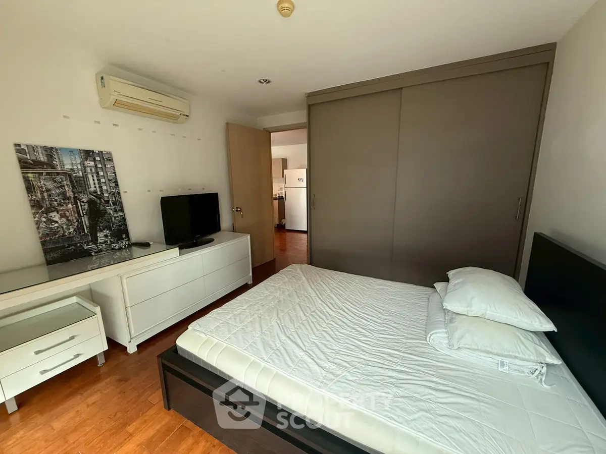 Spacious bedroom with modern furniture and air conditioning in a stylish apartment.