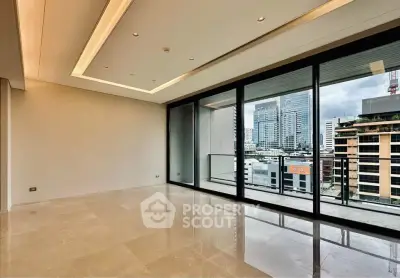 Spacious modern living room with city view and large windows in luxury apartment.
