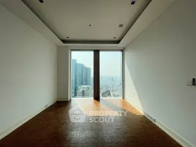 Spacious empty room with stunning city view from large window