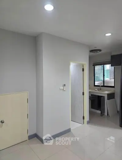 Modern interior with sleek kitchen and neutral tones, perfect for urban living.