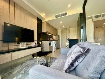 Modern living room with sleek furniture and integrated kitchen appliances