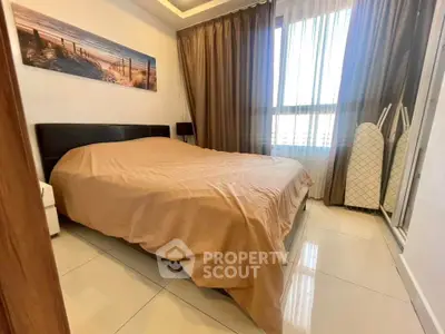 Cozy bedroom with large window and modern decor in a stylish apartment.