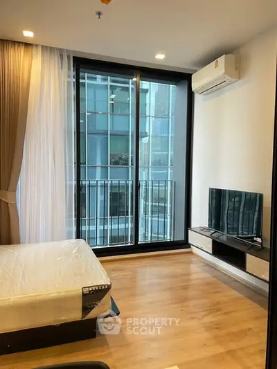 Modern bedroom with balcony view in high-rise apartment