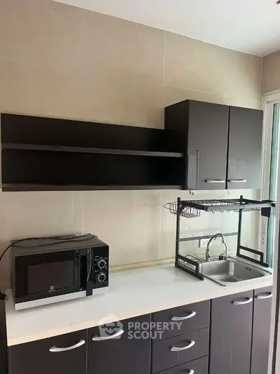 Modern kitchen with sleek cabinets and compact appliances