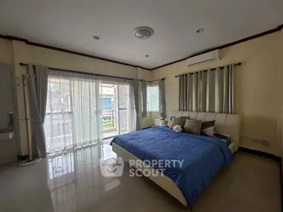 Spacious bedroom with large windows and modern decor