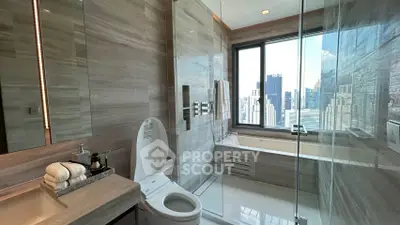 Luxurious bathroom with city view, modern fixtures, and elegant marble finishes.