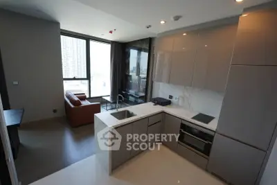 Modern open-layout kitchen with sleek cabinetry and city view, perfect for urban living.