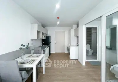Modern open-plan kitchen and dining area with sleek design and natural light.