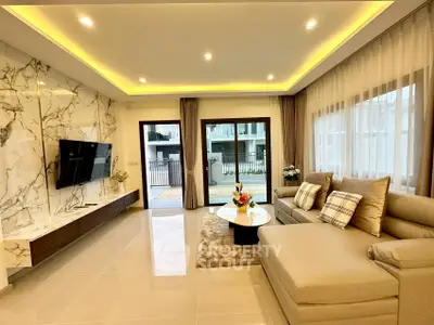 Luxurious modern living room with elegant decor and natural light, featuring a spacious sofa and marble accents.