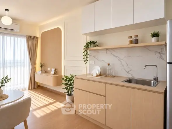 Modern kitchen with open layout and natural light, featuring sleek cabinetry and stylish decor.