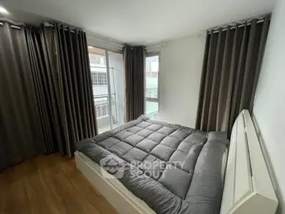 Cozy bedroom with large windows and modern decor in urban apartment