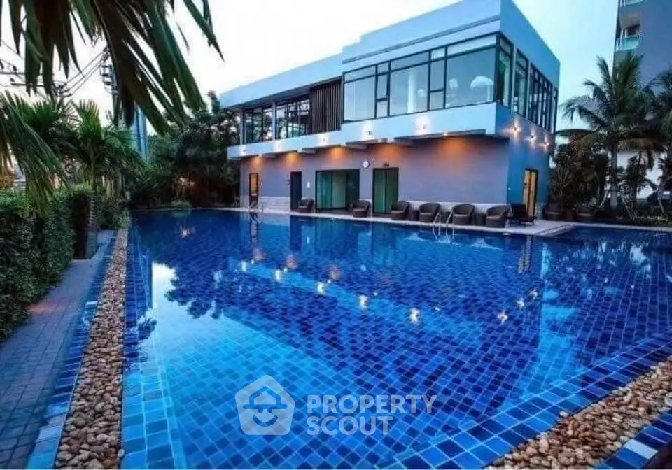Luxurious modern building with stunning pool and lush greenery