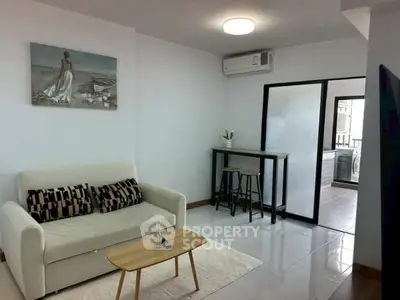Modern living room with stylish decor and balcony access
