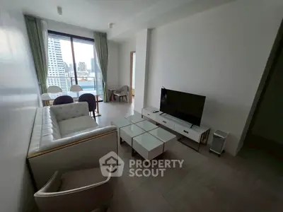 Modern living room with city view, stylish furniture, and natural light