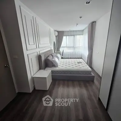 Modern bedroom with stylish decor and large window for natural light