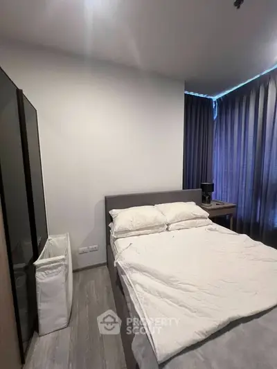 Modern bedroom with cozy bed and stylish decor, perfect for relaxation.