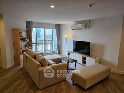 Modern living room with city view, stylish furniture, and natural light.