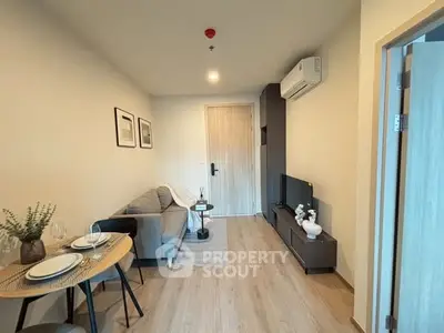 Modern living room with cozy sofa and dining area in stylish apartment.