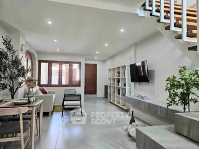 Modern living room with open layout, stylish decor, and natural light