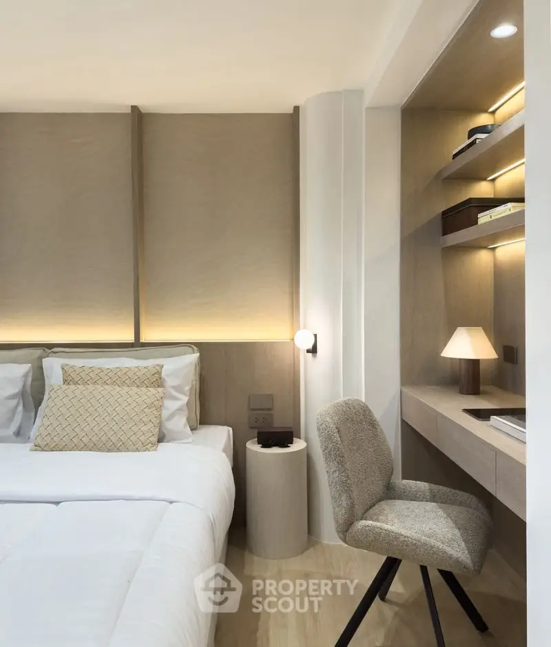 Modern bedroom with cozy study nook and elegant lighting