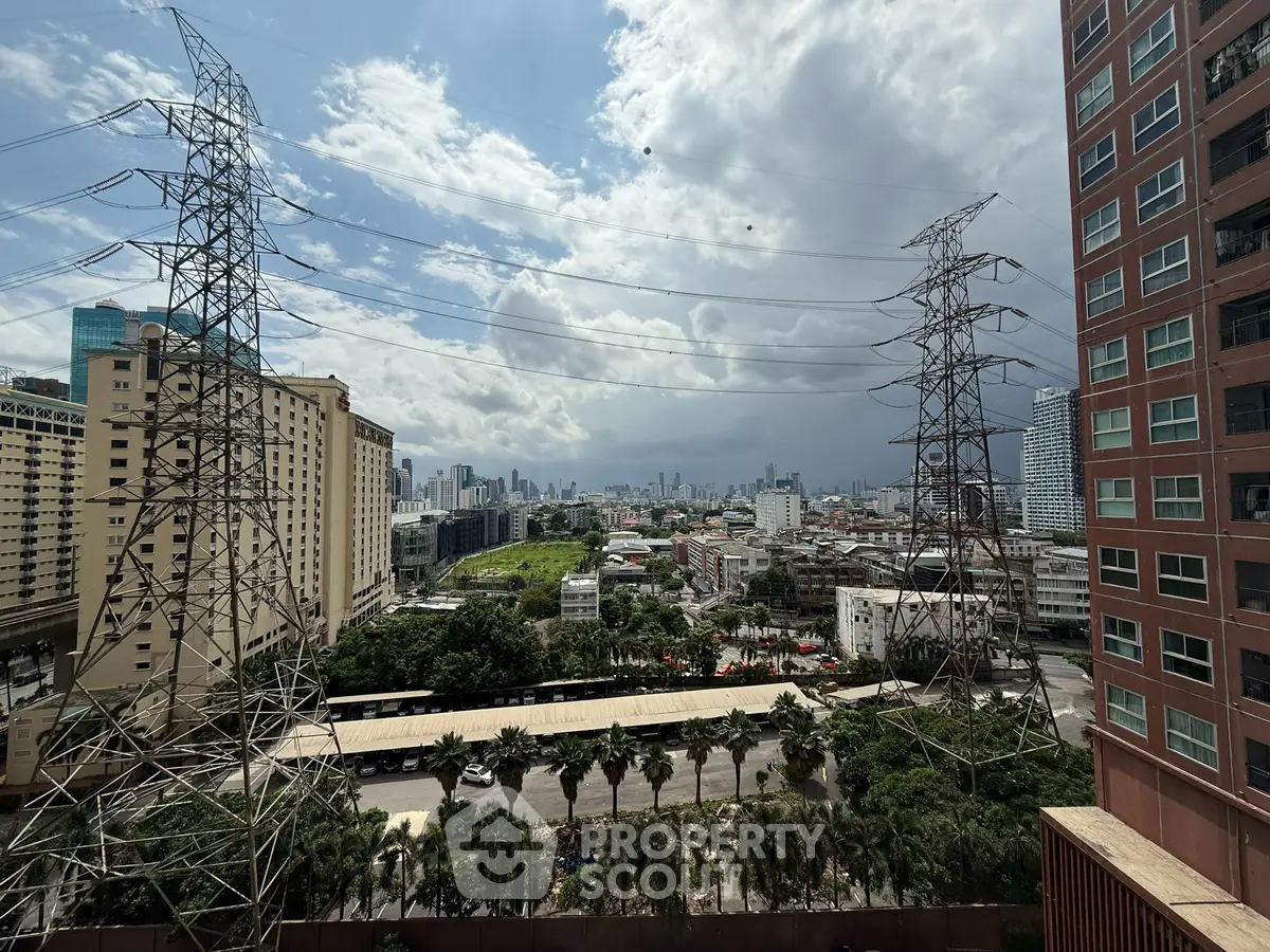 Stunning cityscape view from high-rise building with lush greenery and urban skyline.
