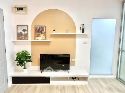 Modern living room with stylish decor and flat-screen TV