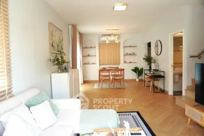 Bright and spacious living room with modern decor and dining area