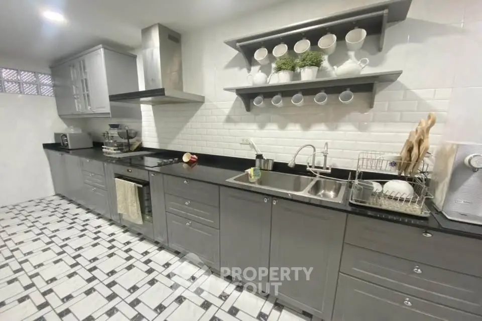 Modern kitchen with sleek gray cabinets and stylish backsplash