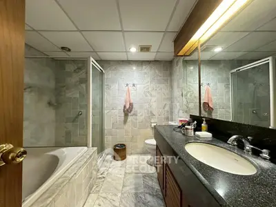 Spacious bathroom with modern fixtures and elegant marble flooring