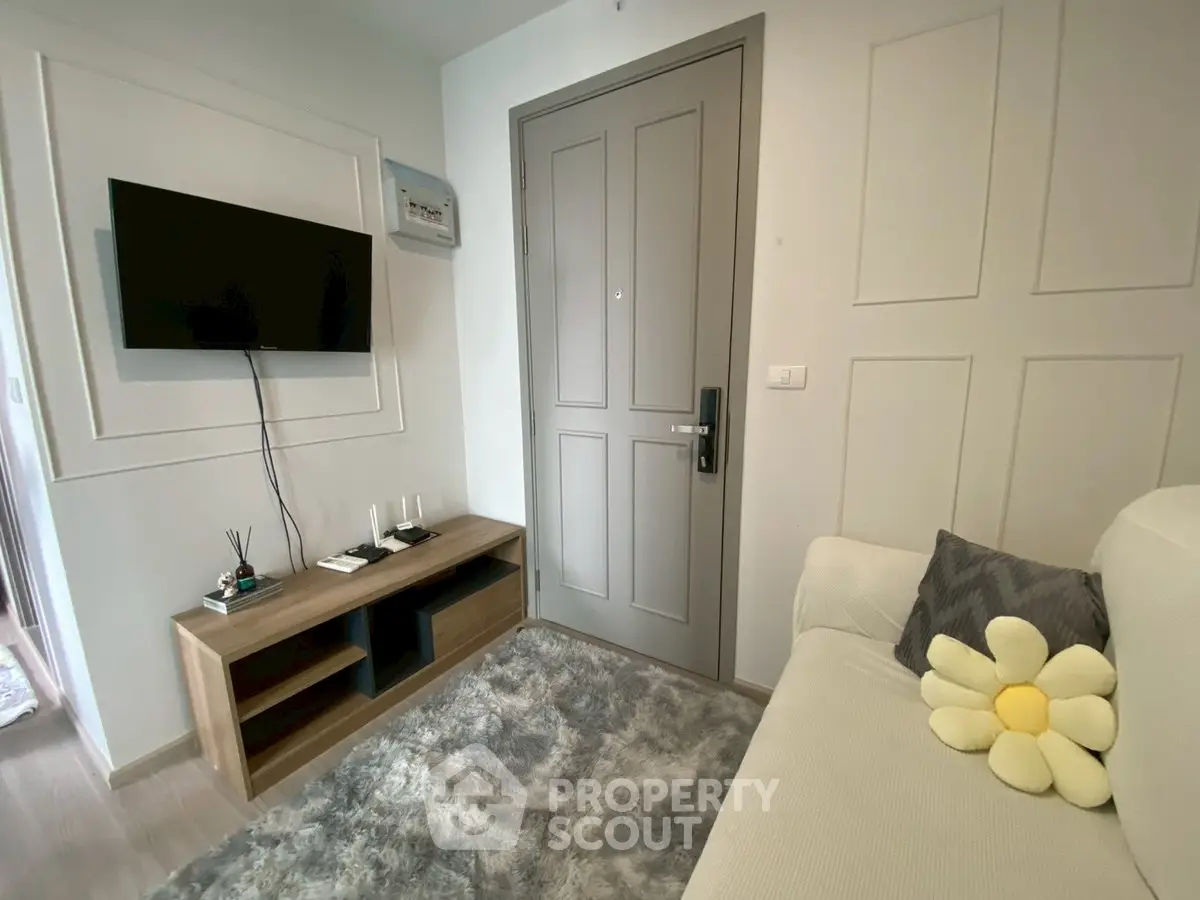 Cozy living room with modern decor and wall-mounted TV