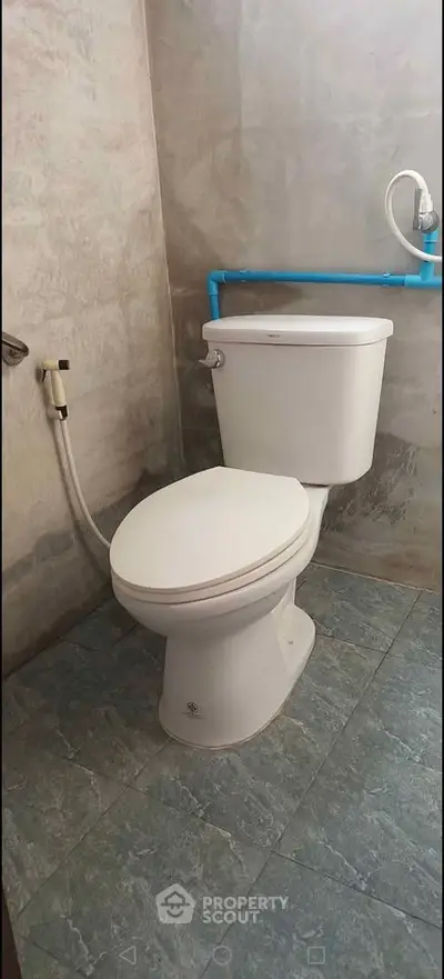 Modern bathroom with sleek toilet and minimalist design, perfect for compact spaces.