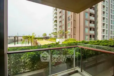 Spacious balcony with lush garden view in modern apartment complex