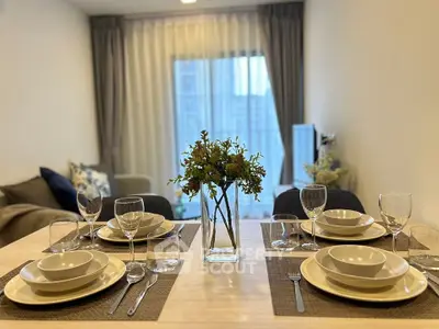 Elegant dining area with modern table setting and cozy living room view.