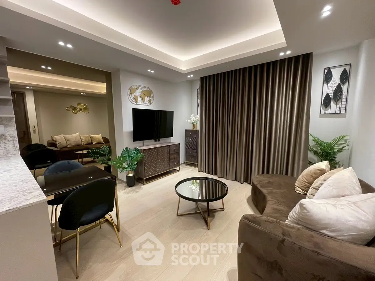 Modern living room with elegant decor, plush sofa, and stylish dining area in open layout.