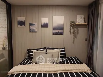 Cozy bedroom with striped bedding and nature-themed wall art