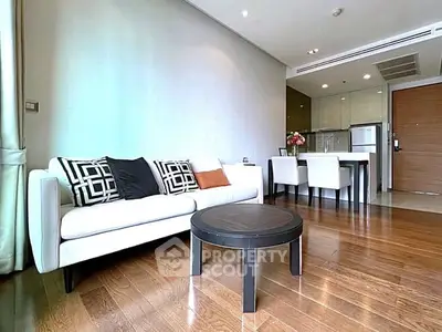 Modern living room with stylish decor and open kitchen layout in a contemporary apartment.