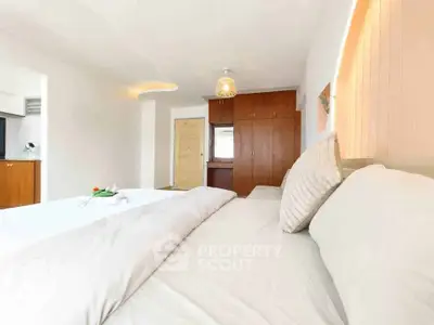 Spacious bedroom with modern decor and ample natural light