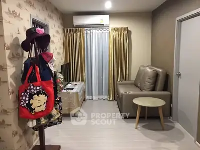 Cozy living room with modern decor and air conditioning, perfect for relaxation.