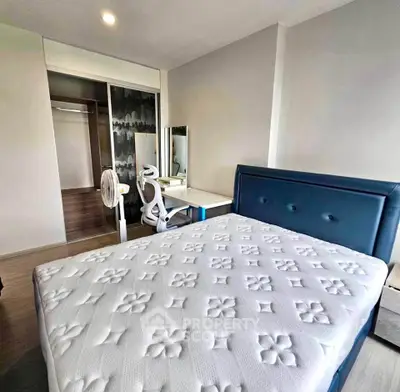 Modern bedroom with stylish blue headboard and sleek furniture in a contemporary apartment.
