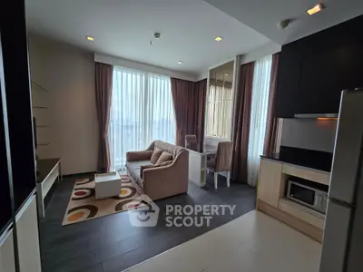 Modern living room with stylish furniture and large windows offering ample natural light.